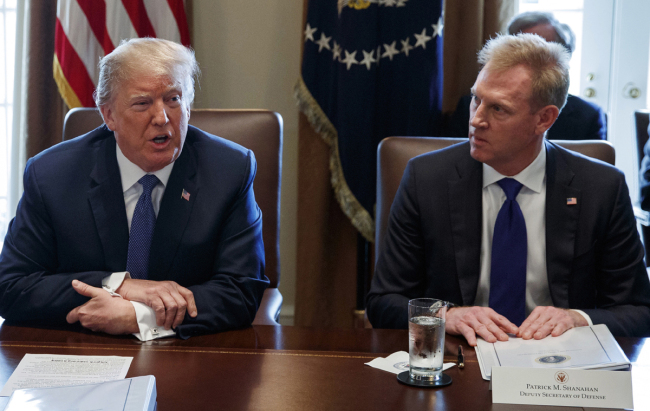 In this April 9, 2018, file ., Deputy Secretary of Defense Patrick Shanahan, right, listen as President Donald Trump speaks during a cabinet meeting at the White House, in Washington. [File Photo: IC]
