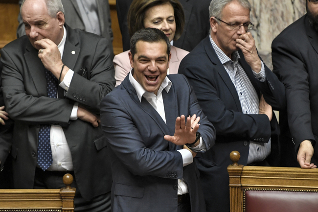 Greek Prime Minister Alexis Tsipras (C) gestures as he is applauded by his lawmakers after his government won the confidence vote at the Greek parliament in Athens on May 10, 2019. [Photo: AFP/LOUISA GOULIAMAKI]