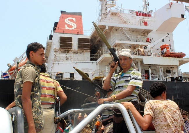 A Yemeni Huthi rebel fighter carries a rocket-propelled grenade launcher (RPG) as he rides with others in the back of a pickup truck during withdrawal from Saleef port in the western Red Sea Hodeida Province on May 11, 2019. [Photo: AFP]