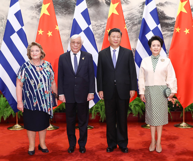 Chinese President Xi Jinping and his wife Peng Liyuan pose for photos with visiting Greek President Prokopis Pavlopoulos and his wife in Beijing on May 14, 2019. [Photo: Xinhua]