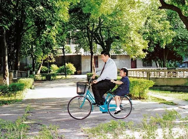 Undated photo showing Xi Jinping riding a bike with his daughter, in Fuzhou, Fujian Province. [Photo: China Plus]