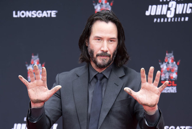 Actor Keanu Reeves shows his hands after placing them in cement during his handprint ceremony at the TCL Chinese Theatre IMAX forecourt on May 14, 2019 in Hollywood, California. [Photo: AFP/Valerie Macon]