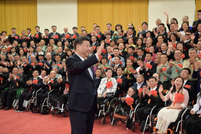 President Xi Jinping meets with representatives attending a ceremony commending role models with disabilities and people who have made outstanding contributions in helping the disabled in Beijing on May 16, 2019. [Photo: Xinhua]
