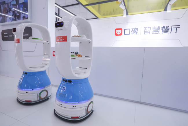 A pair of intelligent robots are delivering food during the Asian Cuisine Festival, Beijing Olympic Park, Beijing, May 18, 2019. [File Photo: IC]