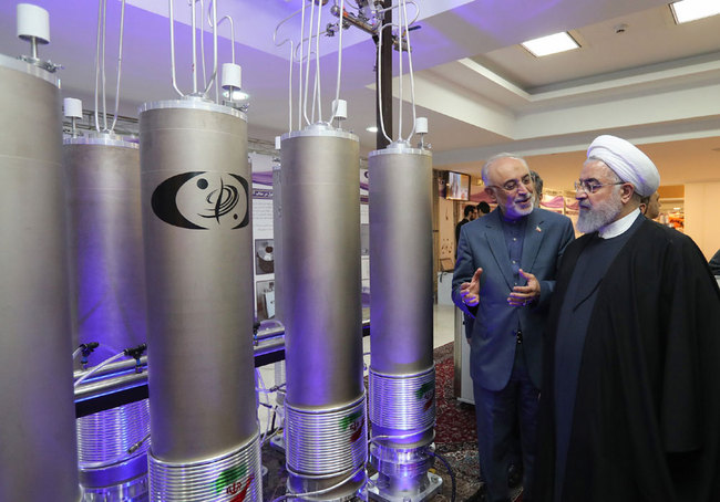 In this file photo made available on April 09, 2019 by the Iranian presidential office, Iranian President Hassan Rouhani (2nd L) listens to head of Iran's nuclear technology organisation Ali Akbar Salehi (R) during the "nuclear technology day" in Tehran. [File photo: Iranian Presidency/AFP]