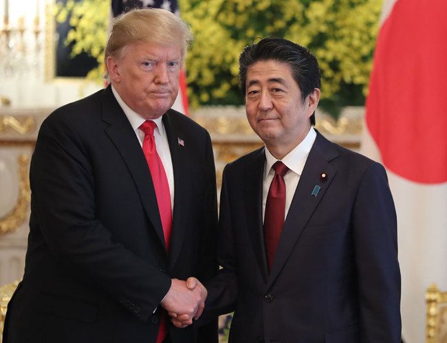 US President Donald Trump shakes hands with Japan's Prime Minister Shinzo Abe (R) after their bilateral meeting at Akasaka Palace in Tokyo on May 27, 2019. [Photo: Pool/AFP/Eugene Hoshiko]