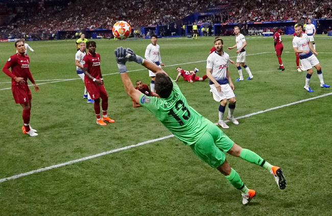 Liverpool's Brazilian goalkeeper Alisson Becker dives to make a save during the UEFA Champions League final football match between Liverpool and Tottenham Hotspur at the Wanda Metropolitan Stadium in Madrid on June 1, 2019. [Photo: AFP]