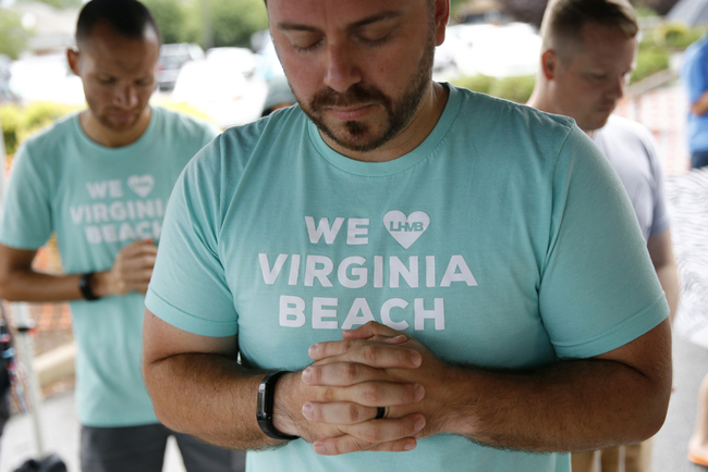 People gather to pray during a vigil in response to a fatal shooting at a municipal building in Virginia Beach, Virginia, Saturday, June 1, 2019. A longtime city employee opened fire at the building Friday before police shot and killed him, authorities said. [Photo: AP]