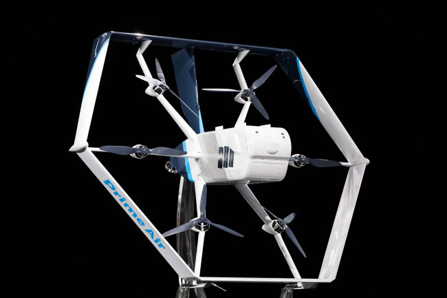 In this image released by Amazon, the company unveils its newest drone design for its "Prime Air" fleet at the Machine Learning, Automation, Robotics and Space conference "re: Mars" in Las Vegas on June 5, 2019. [Photo: AFP/AMAZON/ JORDAN STEAD]