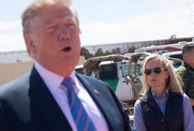 File Photo: Secretary of Homeland Security Kirstjen Nielsen stands alongside US President Donald Trump as he tours the border wall between the United States and Mexico in Calexico, California on April 5, 2019. [Photo: AFP/SAUL LOEB] <br/>