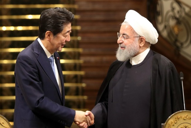 Iranian President Hassan Rouhani (R) shakes hands with Japanese Prime Minister Shinzo Abe, at the Saadabad Palace in the capital Tehran on June 12, 2019. [Photo: AFP]