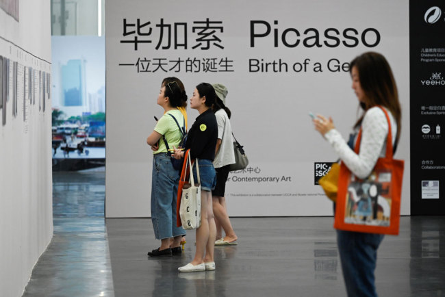 This picture taken on June 14, 2019 shows people visiting an exhibition named "Picasso Birth of a Genius" at an art gallery in Beijing. [Photo: AFP/Wang Zhao]