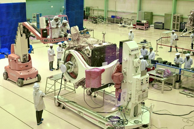 Indian Space Research Organisation (ISRO) scientists work on the orbiter vehicle of 'Chandrayaan-2', India's first moon lander and rover mission planned and developed by the ISRO, in Bangalore on June 12, 2019. [Photo: AFP]