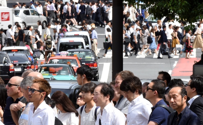 This photo taken on September 15, 2017 shows pedestrians crossing at an intersection in Tokyo. [File Photo: AFP]