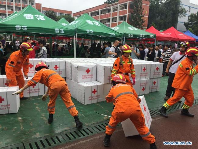Rescue workers handle relief materials at a temporary shelter at Shuanghe Town High School in Changning County of Yibin City, southwest China's Sichuan Province, June 18, 2019. [Photo: Xinhua]