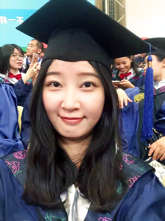 This 2016 selfie provided by her family shows Yingying Zhang in a cap and gown for her graduate degree in environmental engineering from Peking University Shenzhen Graduate School. The 26-year-old visiting scholar at the University of Illinois at Urbana-Champaign, disappeared June 9, 2017. Brendt Christensen, a former graduate student, has been charged with kidnapping and killing her. Zhang's body has not been found. [Photo: AP]