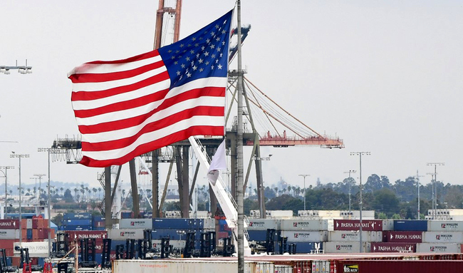 A U.S. flag flies in the foreground as containers are seen at the Port of Los Angeles on June 18, 2019 in San Pedro, California. [Photo: AFP]