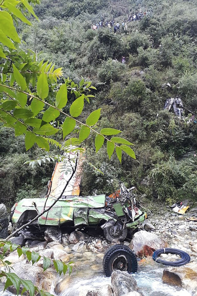 The remains of a bus carrying some 50 passengers are seen after it fell into a 150-metre (500-foot) gorge near Banjar, in the mountainous Kullu district of the Indian state of Himachal Pradesh on June 20, 2019. [Photo: STR / AFP]