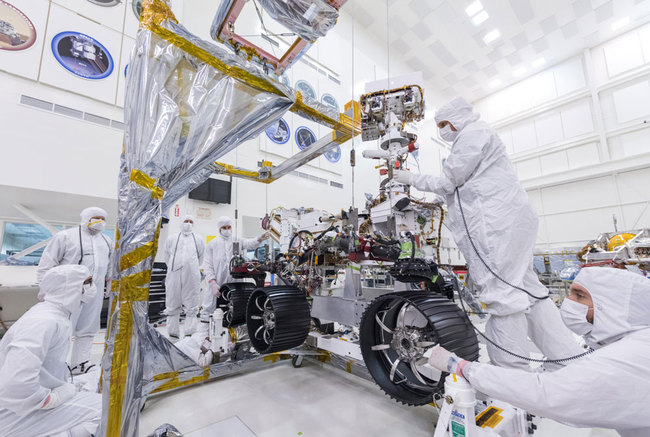 In this image, taken on June 13, 2019, engineers at JPL install the starboard legs and wheels - otherwise known as the mobility suspension - on the Mars 2020 rover. [Photo: NASA/JPL-Caltech]