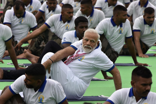 Indian Prime Minister Narendra Modi performs yoga during a mass yoga event on International Yoga Day in Ranchi in eastern Jharkhand state June 21, 2019. Indian Prime Minister Narendra Modi led the way for International Yoga Day on June 21, performing sun salutations and other flexible feats in a mass session with an estimated 30,000 other devotees of the discipline. [Photo: AFP/Rajesh Kumar]