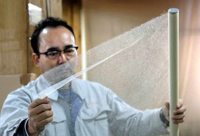 This picture taken on March 15, 2019 shows Hidaka Washi President Hiroyoshi Chinzei, a fourth-generation traditional paper maker, displaying the world's thinnest paper at his factory in Hidaka, Kochi prefecture, some 640 kilometers southwest of Tokyo. [Photo: AFP]