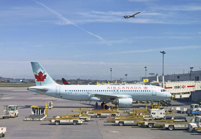 In this file photo taken on May 1, 2018 an Air Canada plane sits on the tarmac at Trudeau airport near Montreal, Canada. [Photo: AFP]