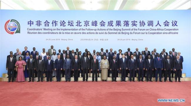 Chinese Vice President Wang Qishan poses for a group photo during a group meeting with the heads of African delegations attending the Coordinators' Meeting on the Implementation of the Follow-up Actions of the Beijing Summit of the Forum on China-Africa Cooperation in Beijing, capital of China, June 24, 2019. [Photo: Xinhua]