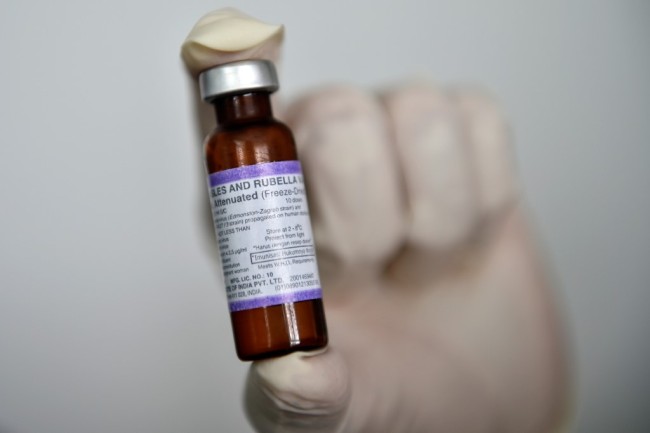 A medical worker holds a measles-rubella (MR) vaccine. [File photo: AFP]