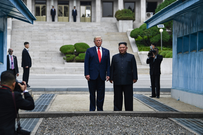 DPRK leader Kim Jong Un stands with US President Donald Trump north of the Military Demarcation Line that divides North and South Korea, in the Joint Security Area (JSA) of Panmunjom in the Demilitarized zone (DMZ) on June 30, 2019. [Photo: AFP]