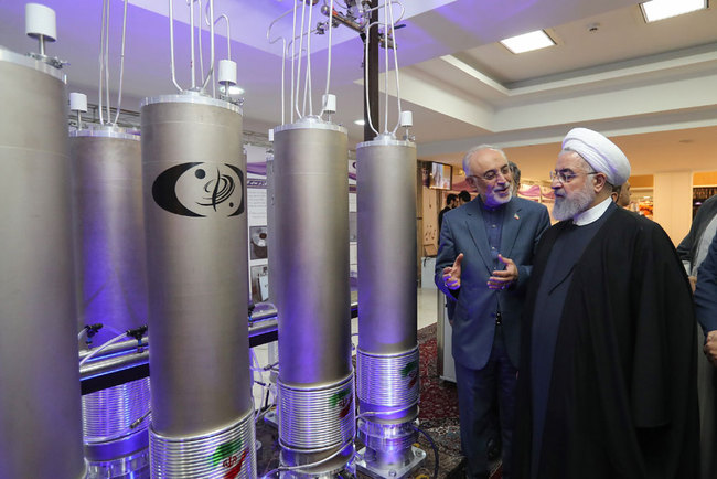 A handout file picture made available by the presidential office shows Iranian President Hassan Rouhani (R) and the head of Iran nuclear technology organization Ali Akbar Salehi inspecting nuclear technology on the occasion of Iran National Nuclear Technology Day in Tehran, Iran, April 9, 2019. [File photo: Iranian Presidency Office/EPA via IC]