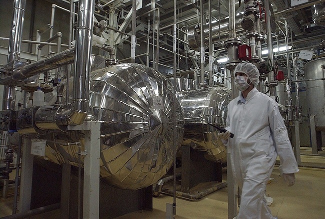 In this March 30, 2005 file ., an Iranian security official in protective clothing walks through part of the Uranium Conversion Facility just outside the Iranian city of Isfahan. [File Photo: IC]