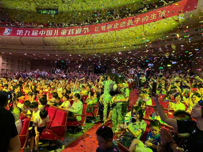 A group of young Chinese students celebrate the opening of this year's China Children's Theater Festival in Beijing on Saturday, July 6, 2019. [Photo provided to China Plus]