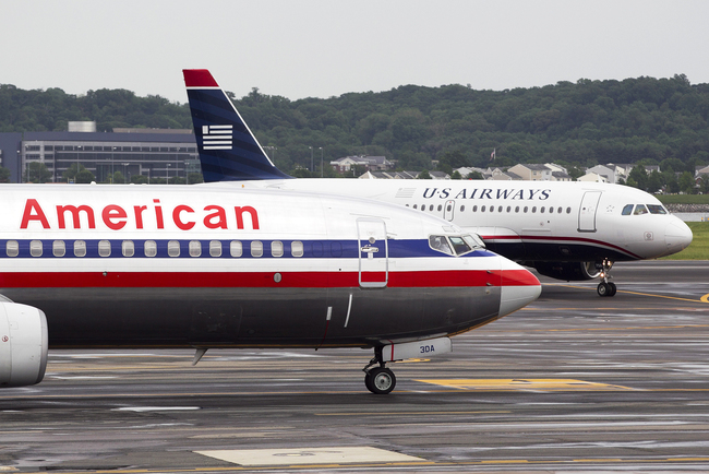 An Airbus A319, operated by US Airways Group Inc., back right, taxis after landing behind a Boeing Co. 737, operated by AMR Corp.'s American Airlines, at Reagan National Airport in Washington D.C., on May 8, 2012. [File photo: VCG]