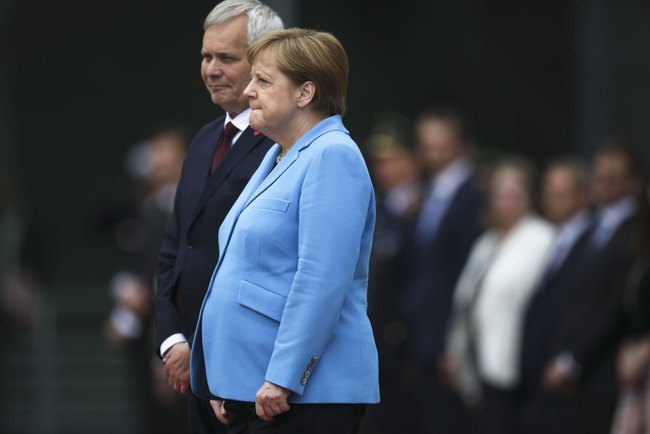 German Chancellor Angela Merkel, right, and Prime Minister of Finland Antti Rinne listen to the national anthems at the chancellery in Berlin, Germany, Wednesday, July 10, 2019. Merkel's body shook visibly as she stood alongside the Finnish prime minister and listen to the national anthems during the welcoming ceremony at the chancellery. [Photo: AP/Markus Schreiber]