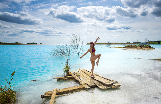 In this undated handout photo taken by mrwed54, a woman poses for a photo by a lake in the Siberian city of Novosibirsk, about 2,800 kilometers (1,750 miles) east of Moscow, Russia. Thousands of Novosibirsk residents, from scantily clad women to newlyweds have been instagramming selfies near the lake nicknamed the “Siberian Malvides” after the far-flung tropical islands in the Indian Ocean. This is in fact is a man-made dumb of coal from a nearby power station that provides for most of Novosibirsk’s energy needs. [Photo: AP/mrwed54]