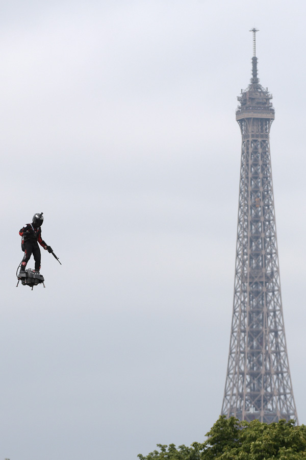 Franky Zapata, inventor, former jet-skiing champion, driving a flyboard over the parade route on July 14, France’s National Day, on the Champs-Elysées in Paris. [Photo: IC]