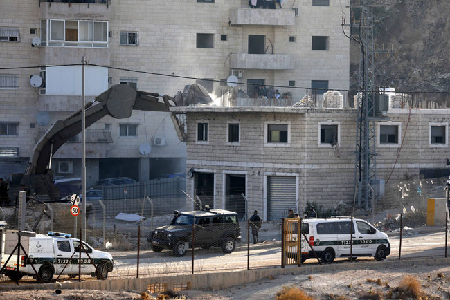 An Israeli army bulldozer demolishes a building in the Palestinian village of Sur Baher, in East Jerusalem, July 22, 2019. [Photo: EPA via IC/Abed Al Hashlamoun]