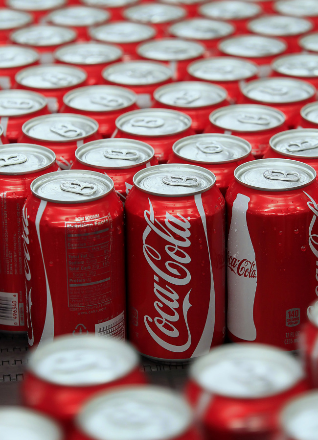 Cans of Coca-Cola Co. soda move along a conveyor belt at the company's Swire bottling plant. [File Photo: VCG]