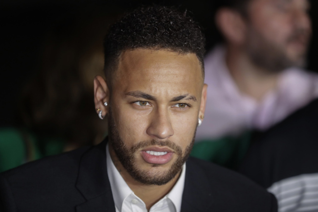 In this June 13, 2019 file photo, Brazil's soccer player Neymar speaks to the press as he leaves a police station where he answered questions about rape allegations against him in Sao Paulo, Brazil. [Photo: IC]