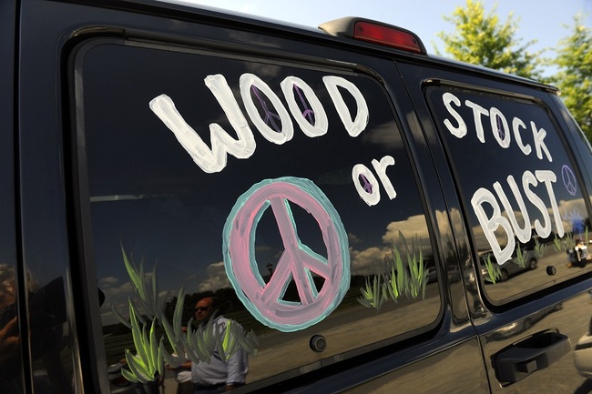 This Aug. 14, 2009 file photo shows a van decorated with "Woodstock or Bust" at the original Woodstock Festival site in Bethel, N.Y. [Photo: AP]