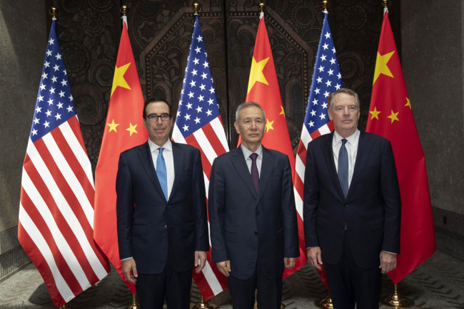 Chinese Vice Premier Liu He (C), U.S. Trade Representative Robert Lighthizer (R), and Treasury Secretary Steve Mnuchin pose for photos before holding talks at the Xijiao Conference Center in Shanghai on Wednesday, July 31, 2019. [Photo: AP via IC]