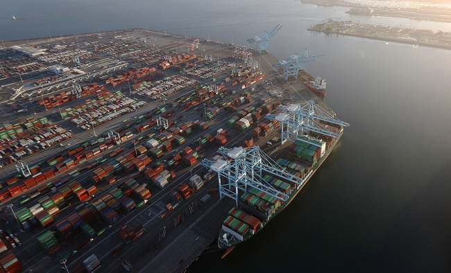 A cargo ship holds shipping containers as other containers sit at the Port of Los Angeles, the busiest container port in the U.S., on September 18, 2018 in San Pedro, California. [Photo: Getty Images via VCG/Mario Tama]