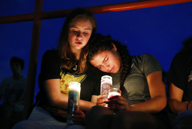 Melody Stout and Hannah Payan comfort each other during a vigil for victims of the shooting that occurred earlier in the day at a shopping center, Saturday, Aug. 3, 2019, in El Paso, Texas. [Photo: AP]