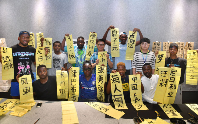 Overseas students from African countries showcase their Chinese calligraphy works at Hunan University Of Technology and Business in Changsha, Central China's Hunan province, on June 27, 2019. [Photo: IC]<br>