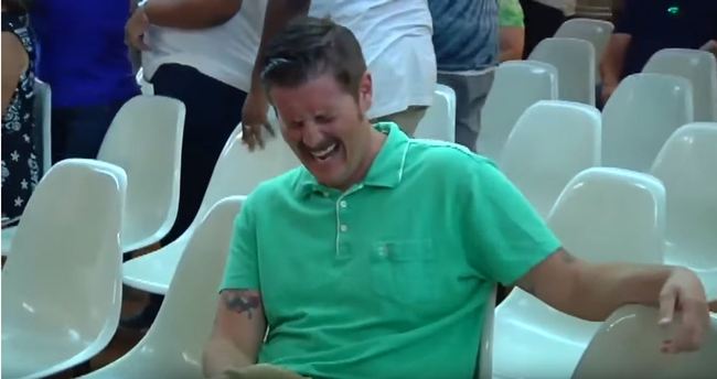 This screeshot of a video shows Alex Kack, in the green shirt laughing at a protester during a vote to put a "sanctuary city" initiative on the November ballot during a meeting of the Tucson, Ariz., City Council Tuesday, Aug. 6. [Photo: Screenshot]