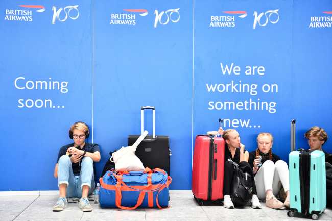 Passengers wait in the departures lounge at Terminal 5 at Heathrow Airport, in London, Britain, August 7, 2019.[File Photo: EPA via IC/NEIL HALL] 