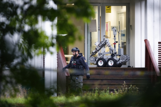 A Police officer with a robot on a site of a shooting inside the al-Noor Islamic center mosque in Baerum outside Oslo, Norway, August 10, 2019. [Photo: EPA via IC/Terje Pedersen]