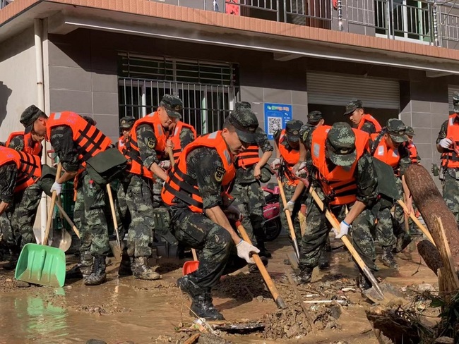 Chinese rescuers clear away stones and mud after a landslide caused by the Typhoon Lekima, the 9th typhoon of the year, in Yinkeng village, Daoshi town, Lin'an district, Hangzhou city, east China's Zhejiang province, August 11, 2019. [Photo: IC]