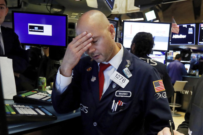 Specialist Mario Picone works on the floor of the New York Stock Exchange, Wednesday, Aug. 14, 2019. The Dow Jones Industrial Average sank 800 points after the bond market flashed a warning sign about a possible recession for the first time since 2007. [Photo: AP/Richard Drew]