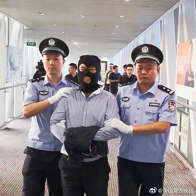 A suspect, whose surname is Huang, is escorted by Chinese police on Saturday, August 17, 2019. [Photo: The Ministry of Public Security]